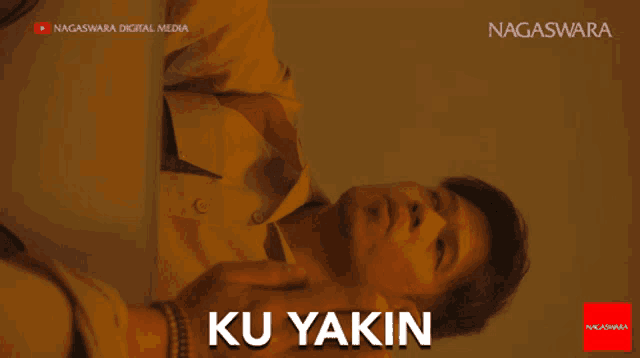 a man is laying down with the words ku yakin written on the bottom