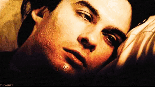 a close up of a man 's face with tvd-art written in the lower right corner