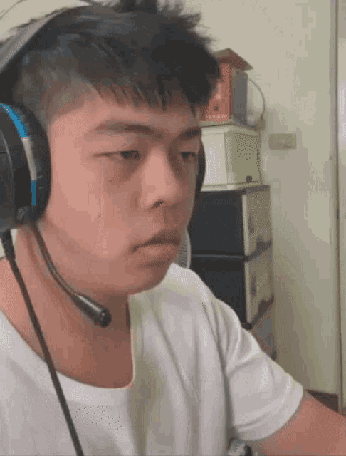 a young man wearing headphones with a microphone on his head