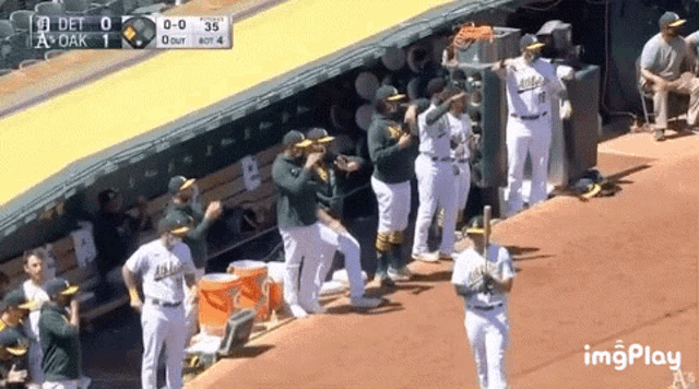 a group of baseball players are standing on a baseball field .