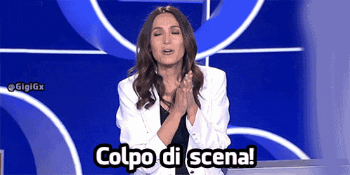 a woman in a white jacket is clapping her hands in front of a blue background that says " colpo di scena "