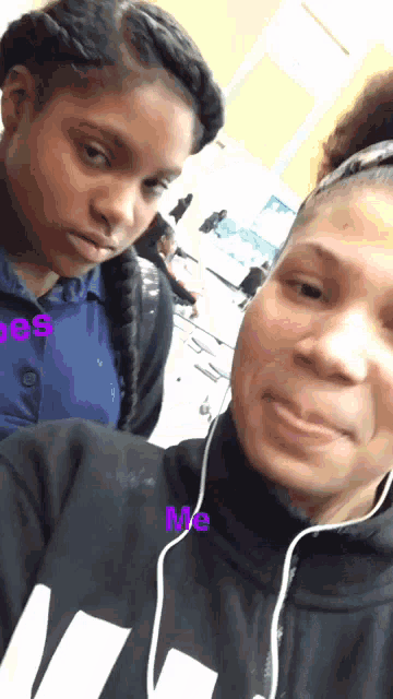 a woman wearing a black sweatshirt with the word me written on it