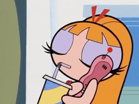 blossom from the powerpuff girls is talking on a cell phone with a straw .