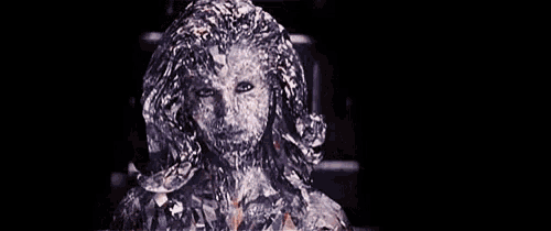 a close up of a woman 's face covered in ice .