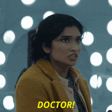 a woman in a yellow coat says " doctor " in yellow letters