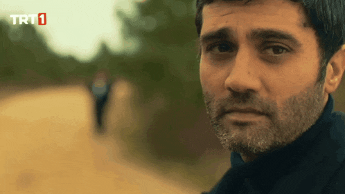 a close up of a man 's face with trt1 on the bottom left