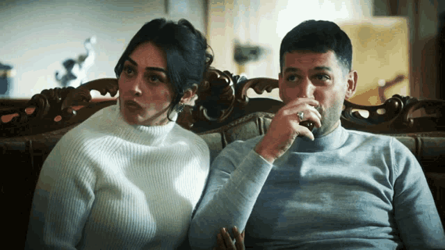 a man and a woman are sitting on a couch
