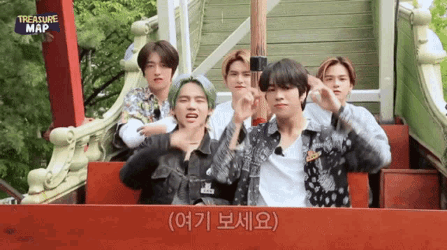 a group of young men are riding a roller coaster with treasure map written on it