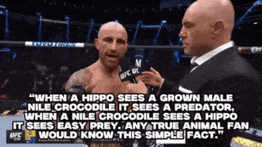 a bald man is being interviewed by a man wearing a microphone that says ufc on it