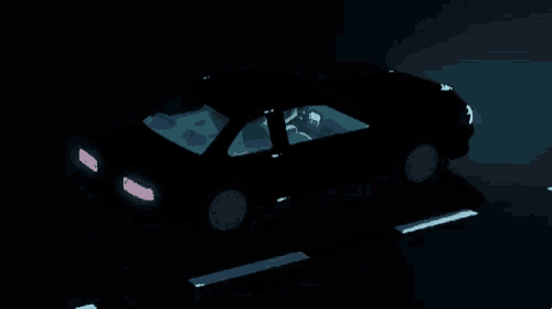 a car is driving down a road at night with a license plate that says t