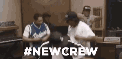 a group of men are dancing in a room with the words `` #newcrew '' written on the bottom .