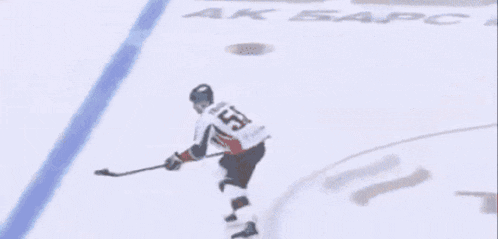 a hockey player with the number 23 on his jersey is skating on the ice