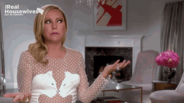a woman in a white polka dot dress is on the real housewives show