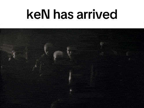 a group of people are standing in a dark room with the words ken has arrived above them