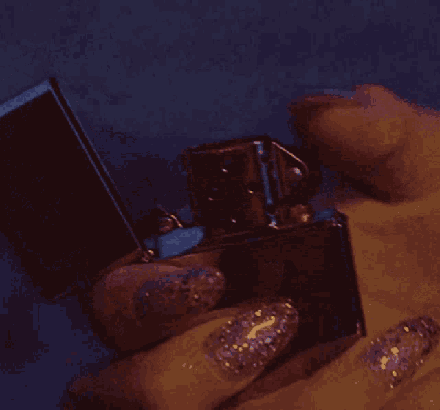 a close up of a person holding a lighter
