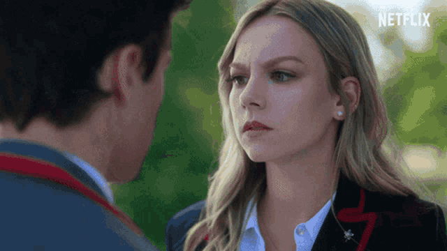 a man and a woman are looking at each other with netflix written on the bottom