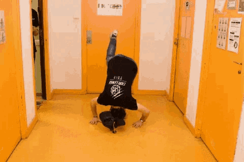 a man wearing a black shirt that says ' thunder city ' on it is kneeling on the floor