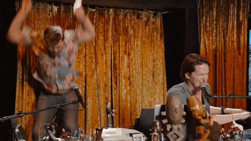 a man is dancing in front of a microphone and a keyboard that says yamaha