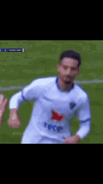 a soccer player in a white jersey with a red star on it is running on the field .