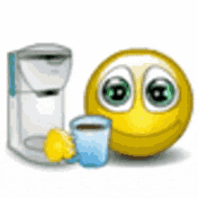 a smiley face next to a coffee maker and a cup of coffee .