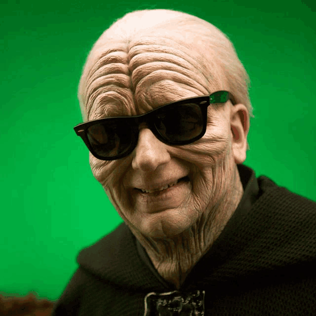 an older man wearing sunglasses and a black sweater