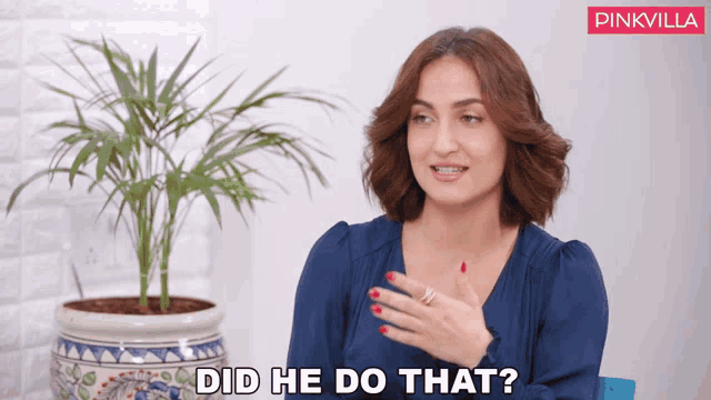 a woman sitting in front of a potted plant says " did he do that "