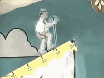 a man is standing on top of a yellow ruler .