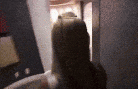 a blurry image of a woman standing in a room