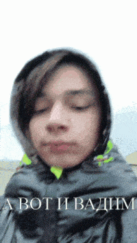 a young man wearing a hooded jacket with the words a bot i badim on the bottom right