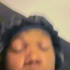 a blurry picture of a person 's face with their eyes closed .