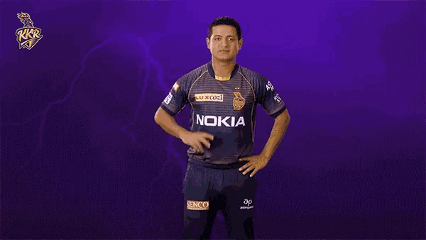 a man wearing a nokia jersey stands in front of a purple background