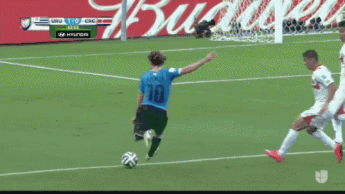 a soccer player wearing number 18 kicks the ball