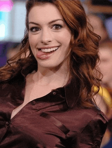 a woman sticking her tongue out while wearing a satin shirt