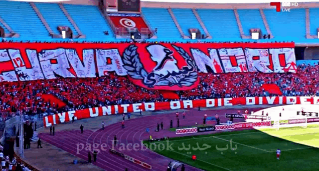 a soccer stadium with a banner that says live united or die divide