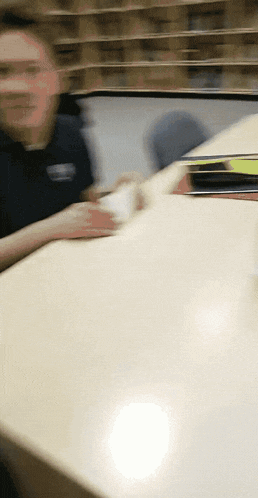 a blurry photo of a man sitting at a table