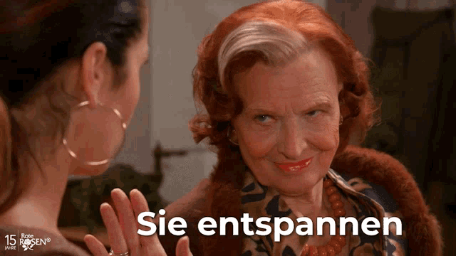 a woman with red hair is talking to another woman and the words sie entspannen are on the bottom