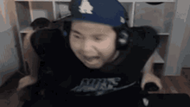 a blurry picture of a person wearing headphones and a hat