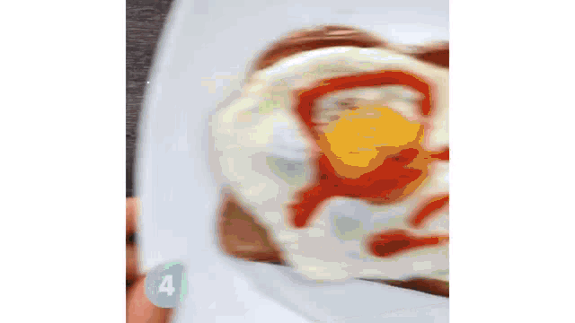 a person is holding a plate with a fried egg on it and a number 4 on it .