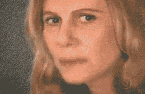 a close up of a woman 's face with a triangle and the numbers 4 and 1b.h.