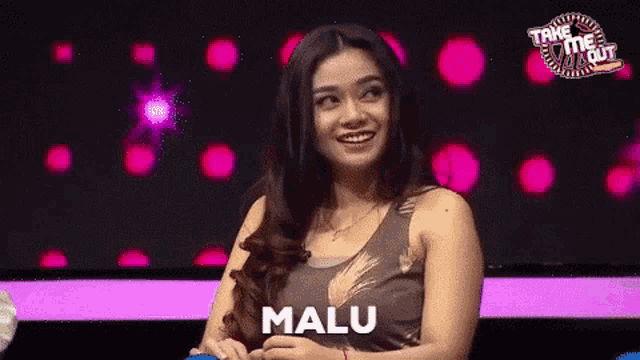 a woman in a tank top with the word malu on her chest