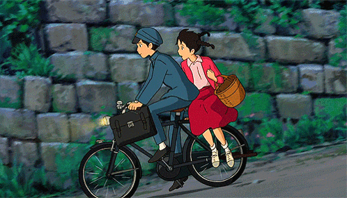 a boy and a girl riding a bike with a basket on the back