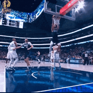 a basketball game is being played in a stadium with a sign that says nbastore.com