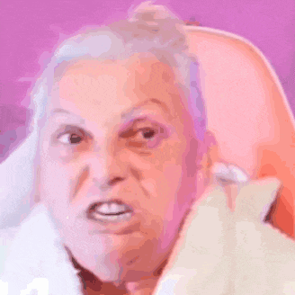 a close up of an elderly woman 's face with a bun on her head .