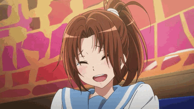 a girl with a ponytail and a blue and white shirt is smiling