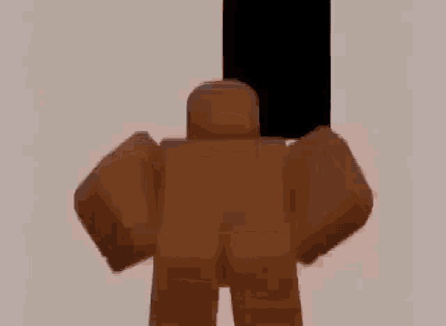 a brown roblox character is standing in front of a white wall with a black square behind him .