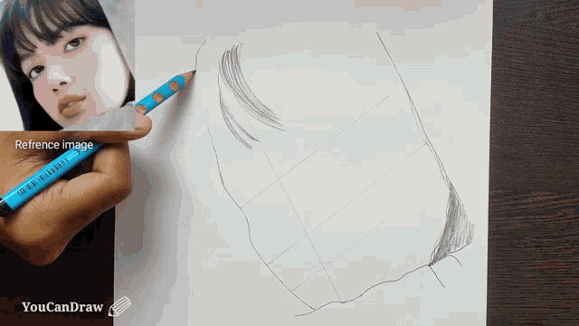 a person is drawing a woman 's face with a blue pencil and a reference image