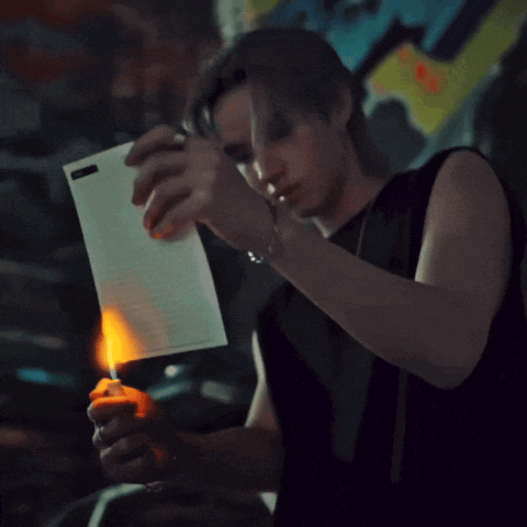 a man in a black tank top is holding a glowing object
