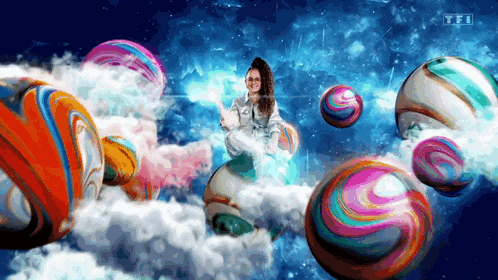a woman is surrounded by colorful balls and says tfi on the bottom right
