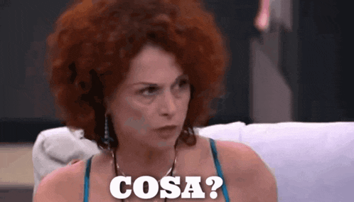 a woman with red hair is sitting on a couch with the word cosa written on her face