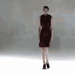 a woman in a red dress is standing on a white floor